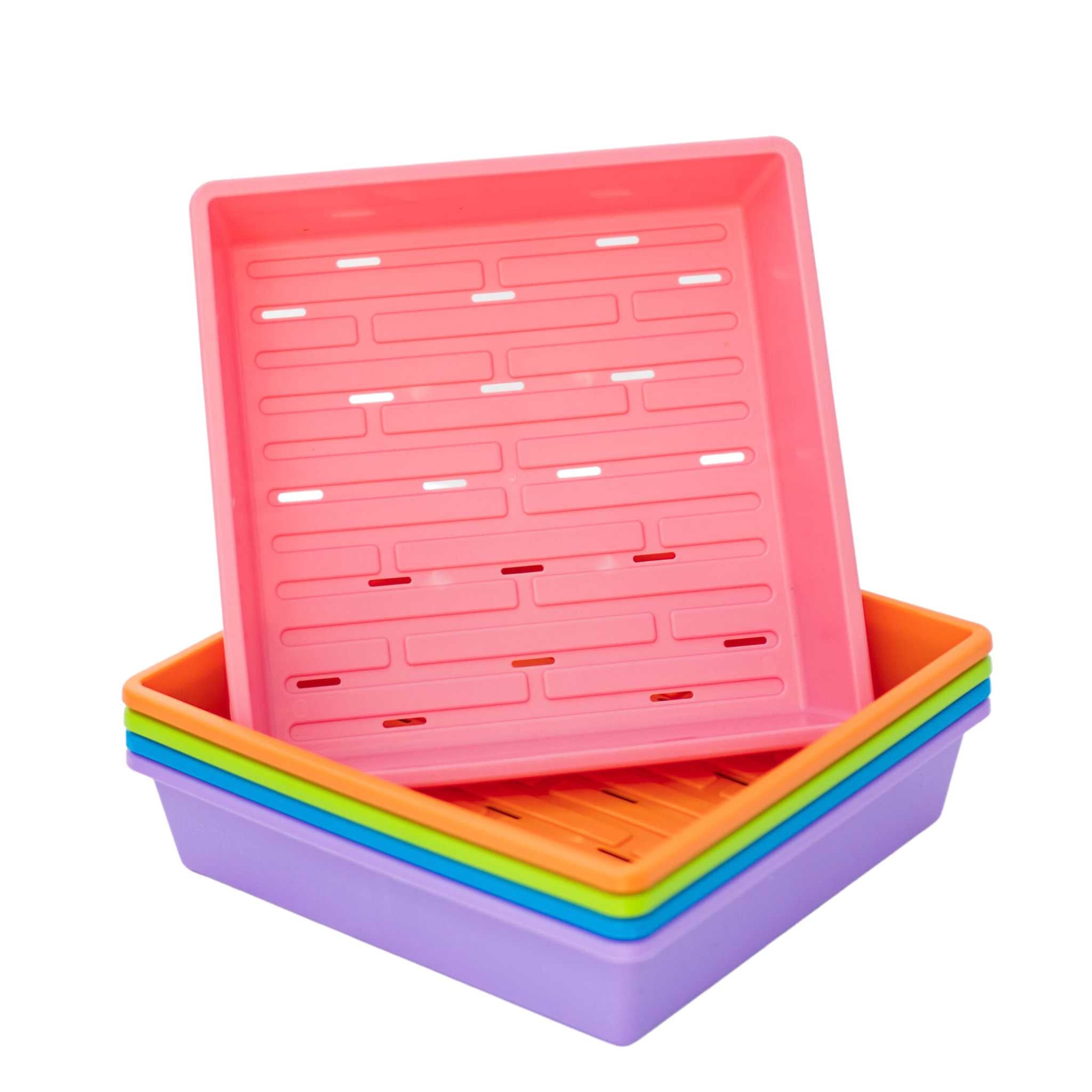 Set of colorful plastic trays stacked on a white background 