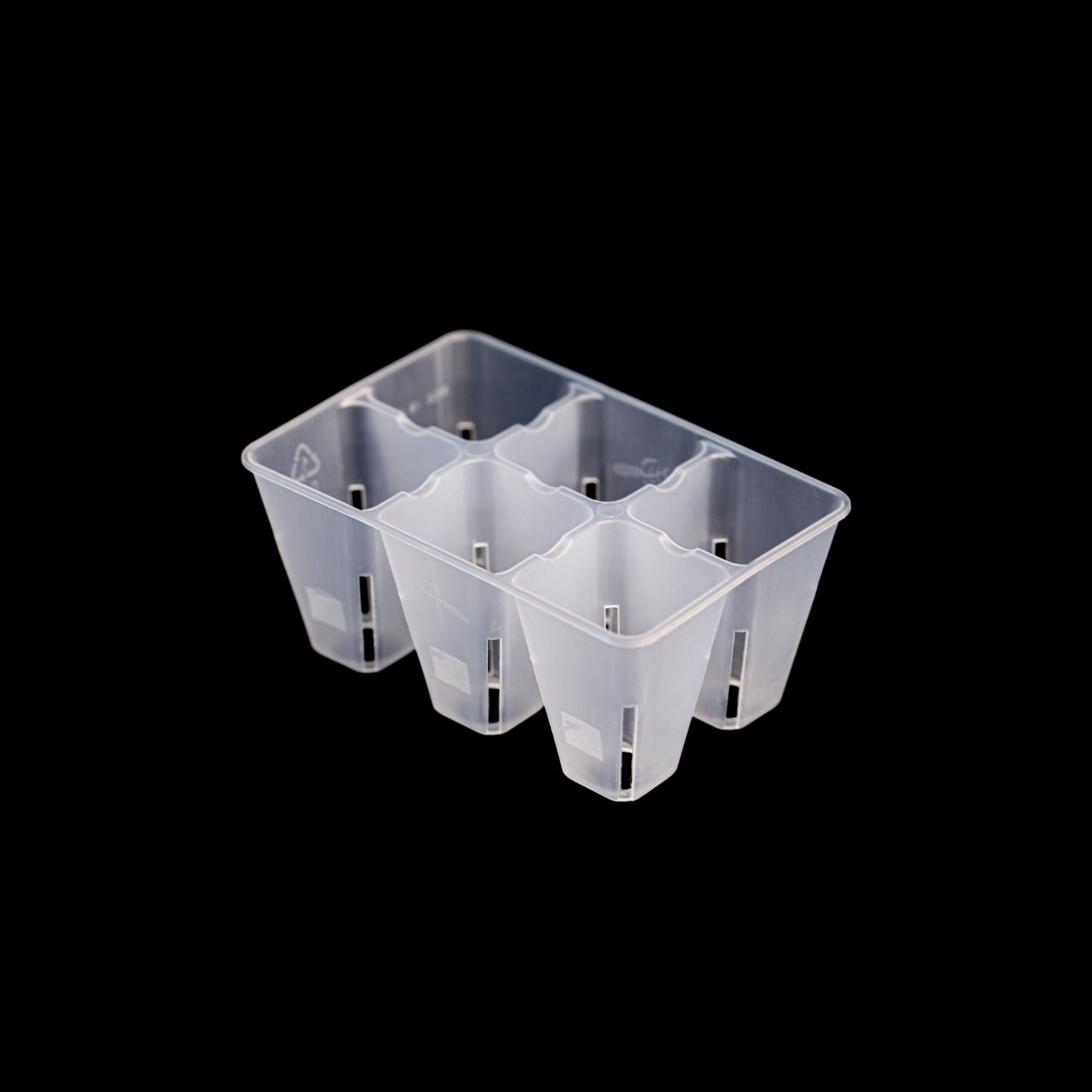 Clear plastic seed tray with compartments on a black background 
