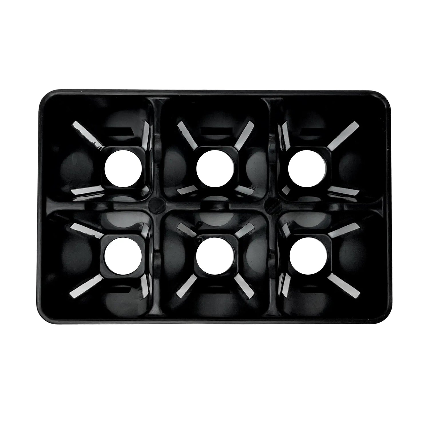 black plastic seed tray inside showing holes on white background 